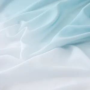 Macro view of soft gradient blue and white pearl chiffon scarf fabric with elegant folds