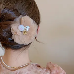 Close-up of mesh flower hair pin detail featuring pearl and diamond heart, sweet hair accessory.