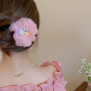 Close-up detail view of the elegant pink mesh flower hair clip with sparkling crystal heart.