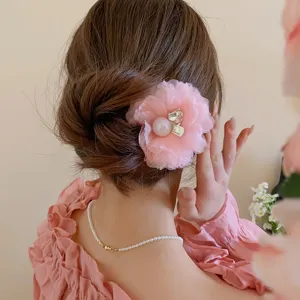 Sweet pink mesh flower hair clip with pearl and rhinestone for charming updo styling.