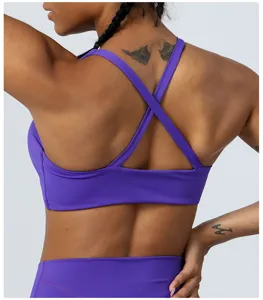 Detail view of the purple cross-back sports bra, showing back straps and breathable fabric.
