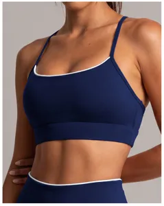 Soutien-gorge de sport pour femme en bleu foncé avec bordure blanche, idéal pour fitness.