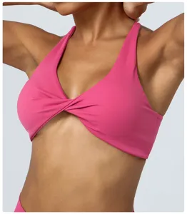 Pink twist front sports yoga bra detail view, comfortable quick-dry fitness activewear.