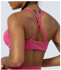 Pink sports yoga bra with stylish cross-strap back design, breathable and comfortable fabric.