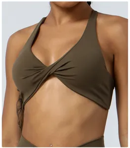 Detail close-up of olive green twist front sports yoga bra, comfortable workout activewear.