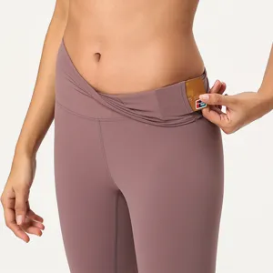 High-waisted cross crossover yoga pants detail showing functional pocket for daily convenience.