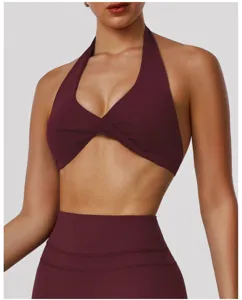 Detailed view of women halter crossover sports bra in burgundy, soft breathable fabric fitness top.
