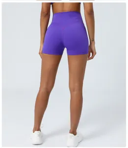 Detail view of high waist purple yoga shorts featuring peach lift and cross back design.