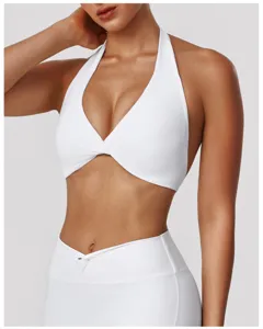 White halter sports bra detail, twist front activewear crop top for fitness and yoga practice.