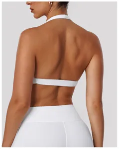 Back view detail of white halter sports bra and yoga top, showcasing breathable activewear design.