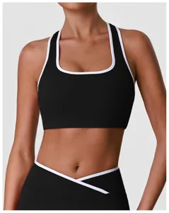 Gros plan détail de la brassière de sport noire avec bordure blanche pour un soutien ajusté.