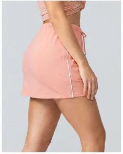 Close-up detail of the pink athletic sports skort showing the side piping and drawstring waist.