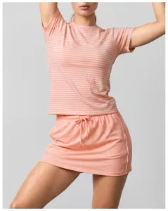 Detailed view of women pink striped active t-shirt and pleated sports skirt with inner shorts.