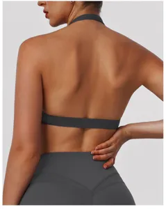 Back detail of dark grey halter yoga sports bra, featuring hollow design and breathable athletic fabric.