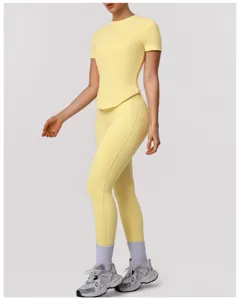 Close-up detail of the yellow athletic short-sleeve top and high-waist leggings set.