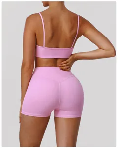 Back view detail of pink high-waisted sports shorts and fitness bra set for yoga workouts.