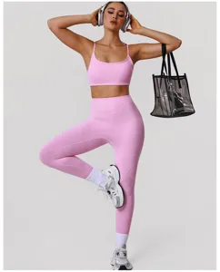 Pink sports bra and leggings yoga set model detail view with transparent tote bag and headphones.