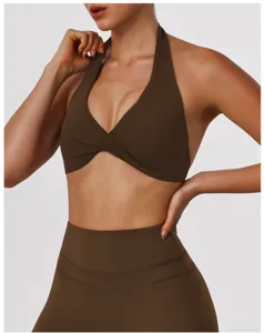 Detail shot of the brown halter yoga bra showing the cross front design and fabric.