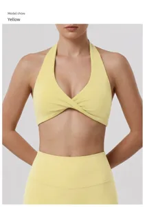 Close-up of yellow halter yoga bra, featuring a front twist cut-out and supportive fit.