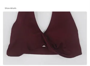 Detailed view of wine red halter sports bra with front twist design for yoga and fitness.
