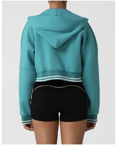 Back view of teal cropped zip-up hoodie featuring contrast white striped hem and cuffs detail.