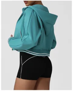 Detail view of women zip-up cropped hoodie featuring contrast stripe hem and active shorts.
