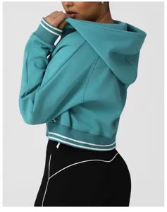 Detailed view of women's teal cropped zip hoodie with white striped ribbed trim and cuffs.