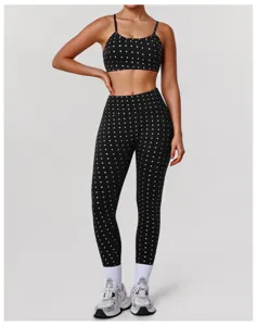 Vue détaillée du soutien-gorge de sport élégant à pois argentés et du legging de yoga taille haute.