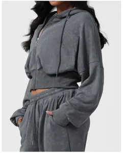 Detail view of washed grey cropped zip hoodie and sweatpants set, casual sportswear.