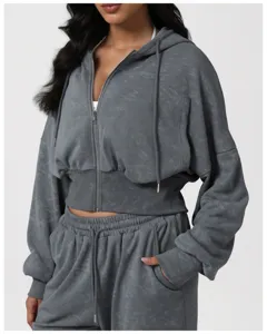 Detailed view of dark gray cropped zip-up hoodie and matching casual sweatpants activewear.
