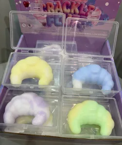 Assorted pastel croissant squishy toys packaged individually in clear display boxes