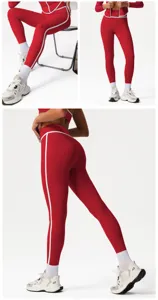 Detailed view of red high-waisted activewear yoga leggings with white side stripes.