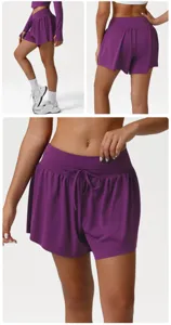 Detail view of high-waisted purple athletic shorts featuring a relaxed fit and drawstring.