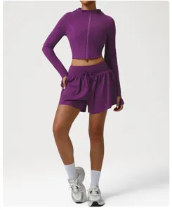 Details of the purple athletic jacket and shorts set, showing stretchy activewear fabric.