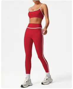 Red activewear set detail featuring sports bra and high-waist leggings with white trim.