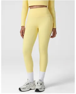 Women yellow high waist yoga pants set with long sleeve crop top and side pockets.