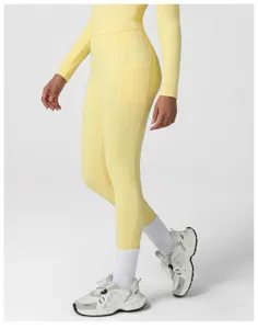 Detailed view of high-waisted yellow yoga leggings with convenient side pocket and top.