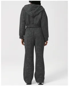 Back view of a dark grey acid wash hooded activewear set featuring a crop jacket and pants.