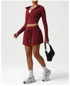 Detailed view of the women athletic crop jacket and high waist shorts activewear set in red.