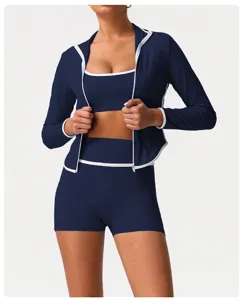 Three-piece athletic yoga set featuring zip jacket, sports bra, and high-waist shorts.