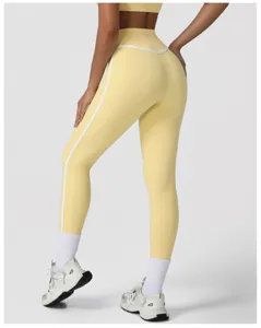 Close-up detail of high-waist push-up yoga leggings with white side stripes and stretch fabric.