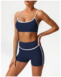 Detailed view of the dark blue athletic yoga set, featuring contrast white trim and high-waisted shorts.