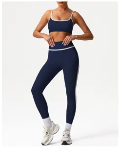 Women navy blue activewear set high waist sports bra and yoga leggings with white trim.