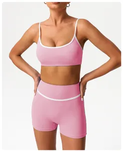 Detailed view of the pink athletic yoga set, featuring contrast white piping and a stylish fit.