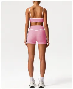 High waisted athletic workout set pink sports bra and yoga shorts for fitness running gym.