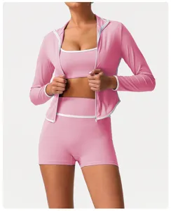 Pink activewear set featuring hooded zip jacket sports bra and high waisted shorts detail view.