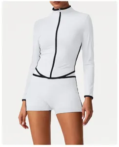 White athletic long-sleeve zip top and shorts set, fitted activewear detail view for gym workouts.