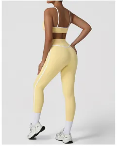 Detailed view of back and hip showing the yellow athletic sports bra and high waist leggings.