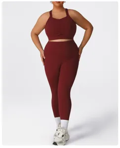 Detail view of plus size wine red yoga set featuring cross back sports bra and high waist leggings.
