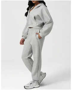 Detail view of a cozy grey zip-up hoodie and matching sweatpants set, comfortable casual wear.